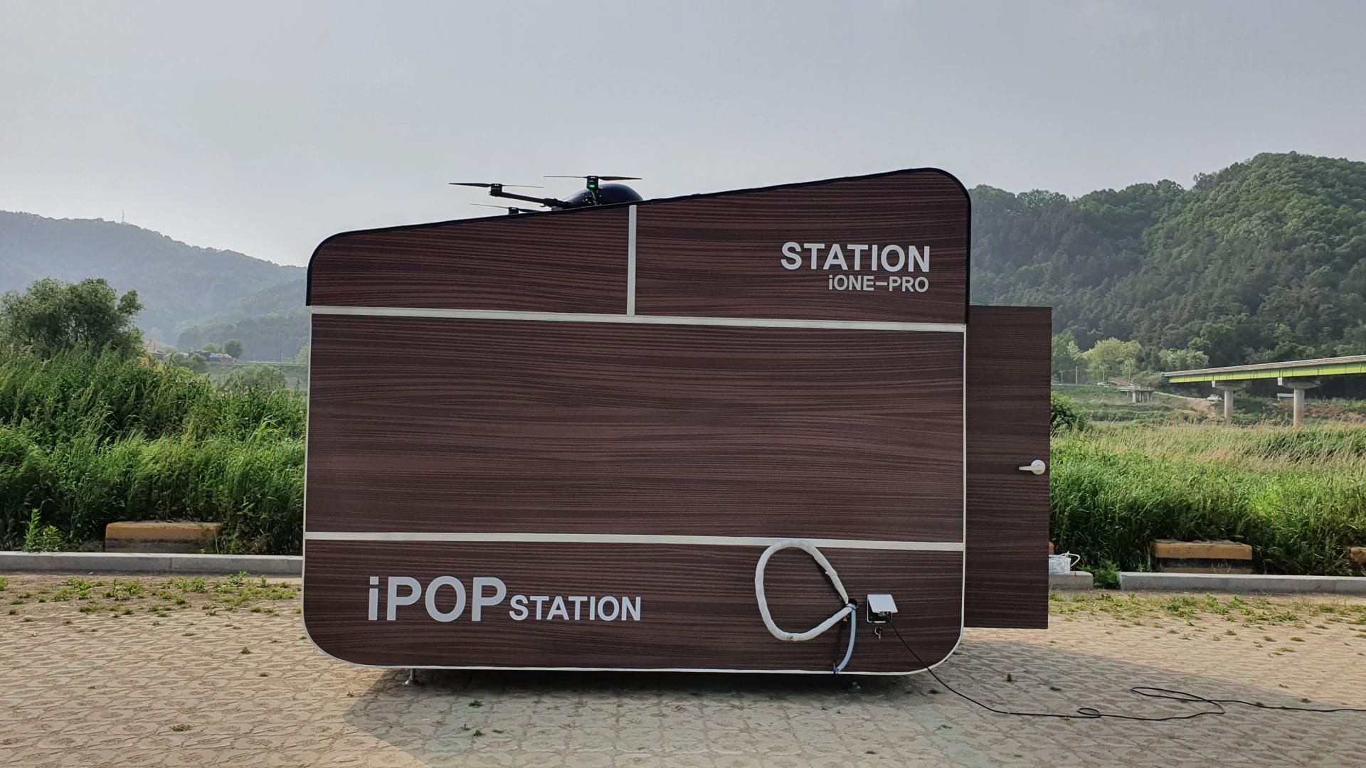 iONE-PRO drone station with a drone on its rooftop landing platform