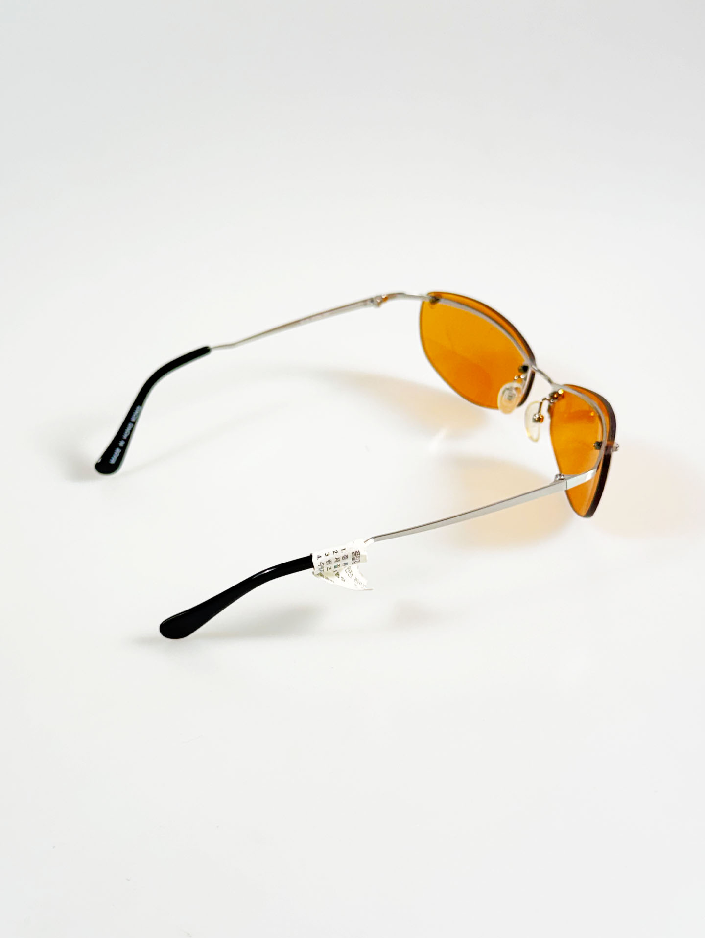 SILVIO VALENCIA Silver Rimless Oval Metal Orange Tint Sunglasses