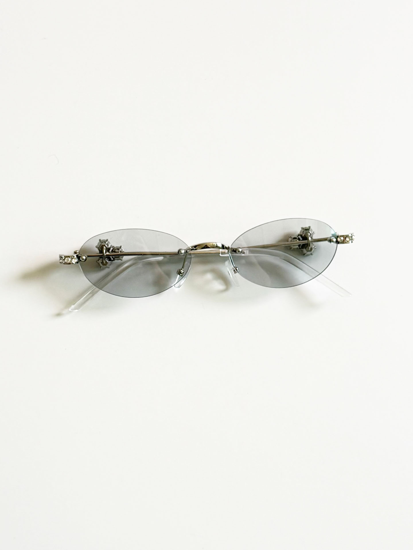 Crystal Detail Rimless Oval Silver Metal Frame Sunglasses