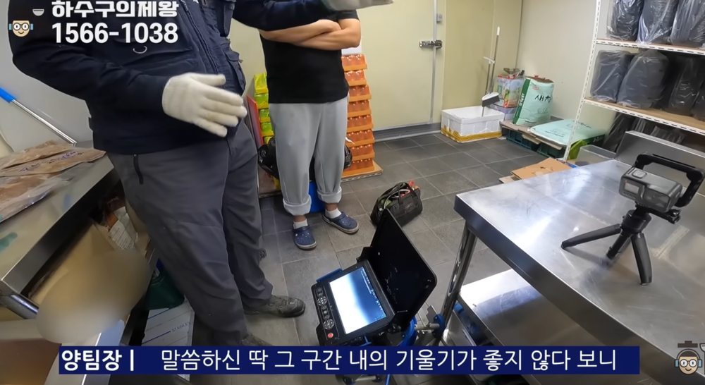 내시경 장비 모니터를 통해 특정 구간의 배관 기울기 문제를 설명하는 장면