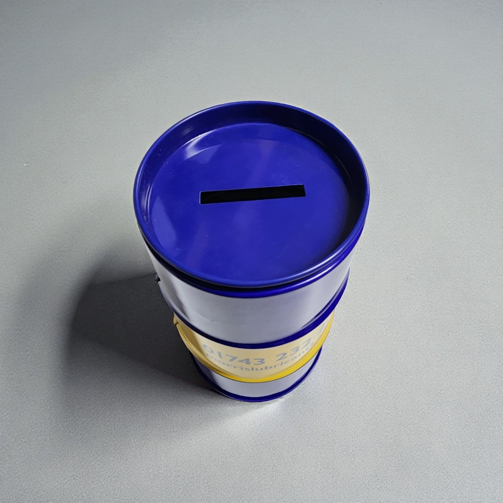 동전 투입구가 있는 파란색 뚜껑의 드럼통 틴케이스 저금통 상단