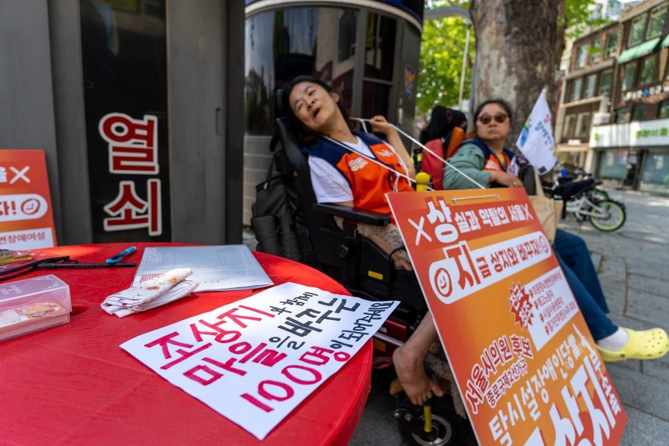 서울시의원 종로구제2선거구 본후보 등록에 필요한 추천인 100명의 서명을 받기 위해 거리에서 시민들의 서명을 받고 있는 조상지 씨. 테이블 위에는 추천인 명부와 ‘조상지 후보를 서울시의회로!’라고 적힌 손팻말이 놓여 있다. 사진 탈시설장애인당
