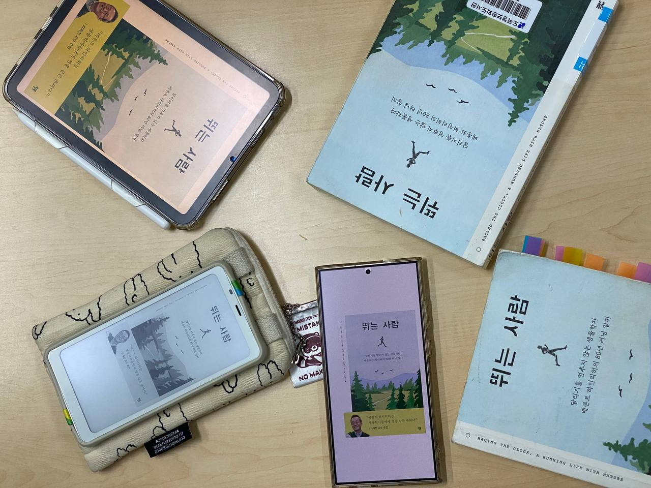 책 '뛰는 사람'이 여러 권 책상 위에 늘여져있다.