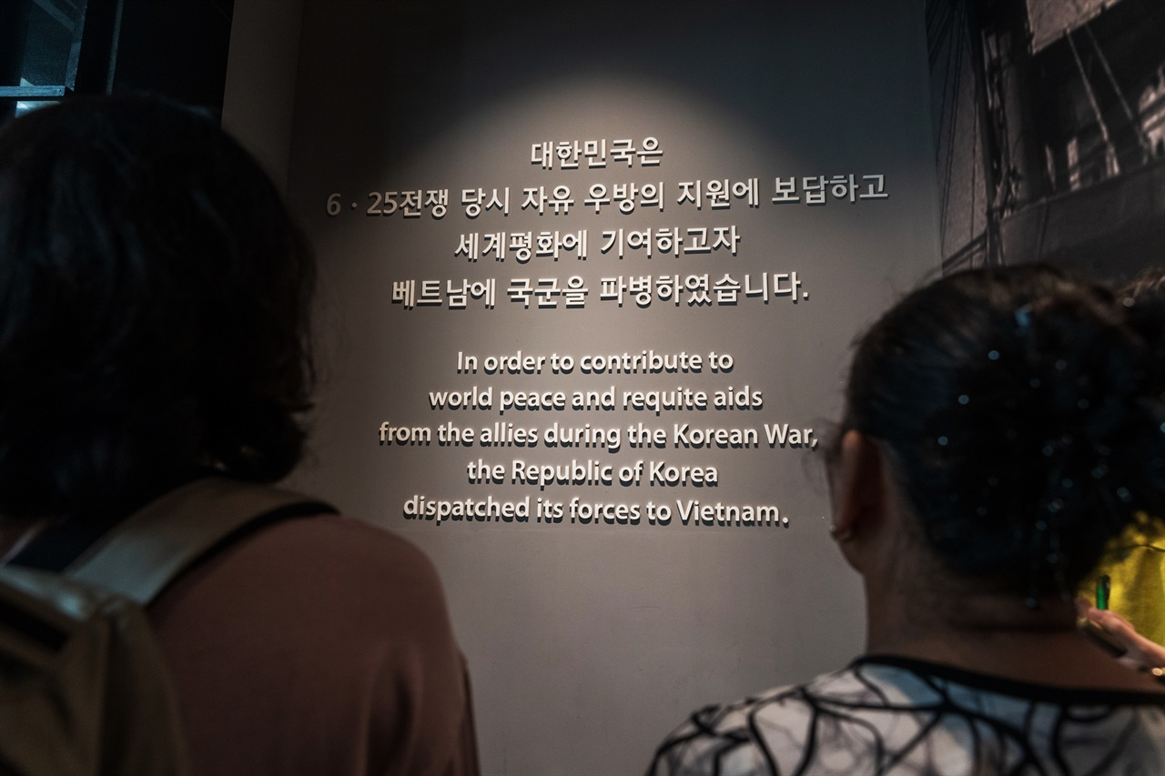 베트남전 전시관 초입에 전시된 문구를 보고 있는 퐁니학살 피해생존자 응우옌티탄. 그는 한국군에게 죽임을 당한 가족을 언급하며 이 문구가 거짓이라고 했다.
