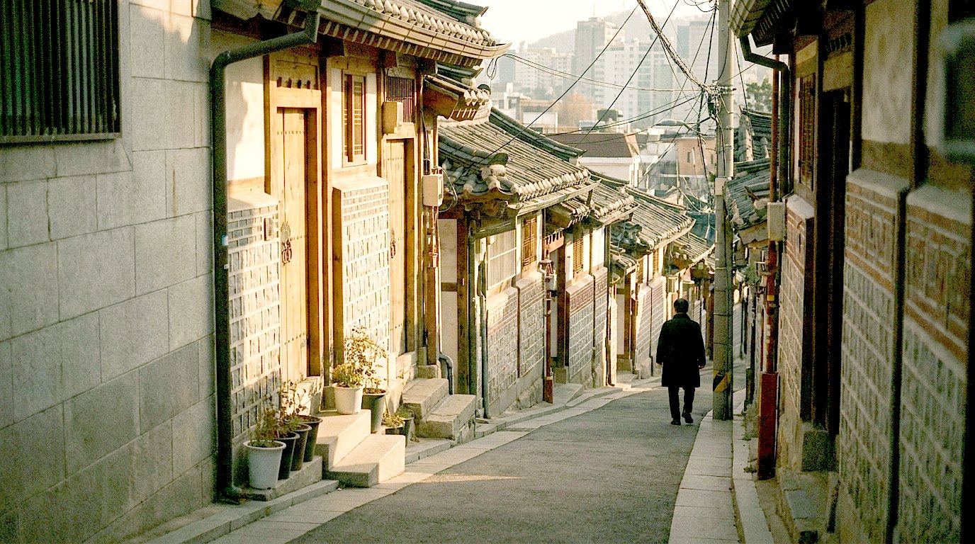 A quiet sloping alleyway of tile-roofed houses in the Seochon quarter of Seoul