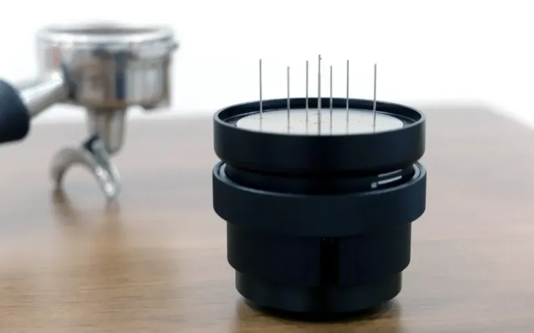 A Duomo the Eight coffee ground distribution tool on a countertop.