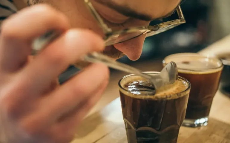 A coffee professional assesses coffee tasting notes at a roastery.