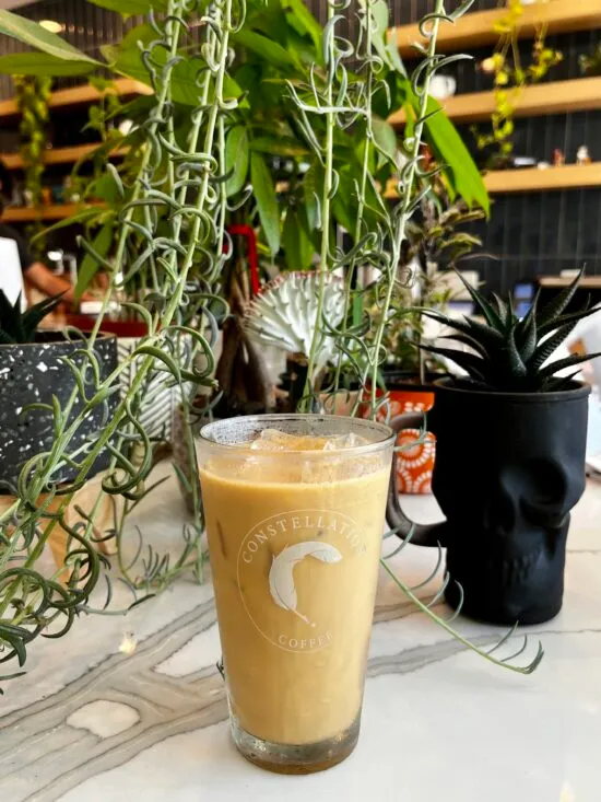 An iced salted maple latte on a counter.